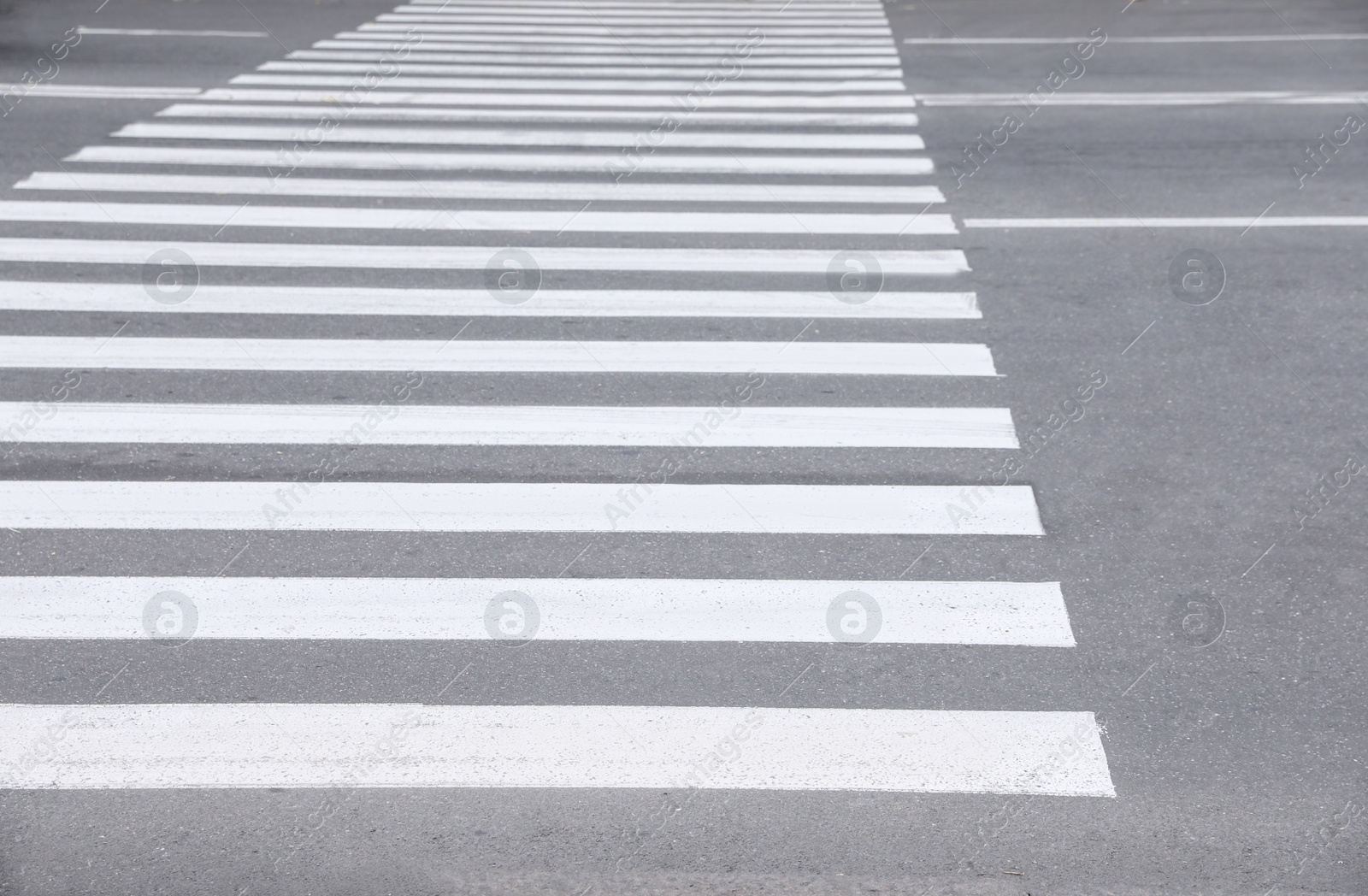 Photo of White pedestrian crossing on empty city street