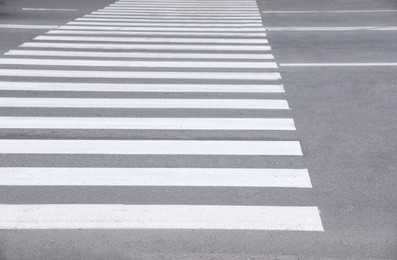 Photo of White pedestrian crossing on empty city street