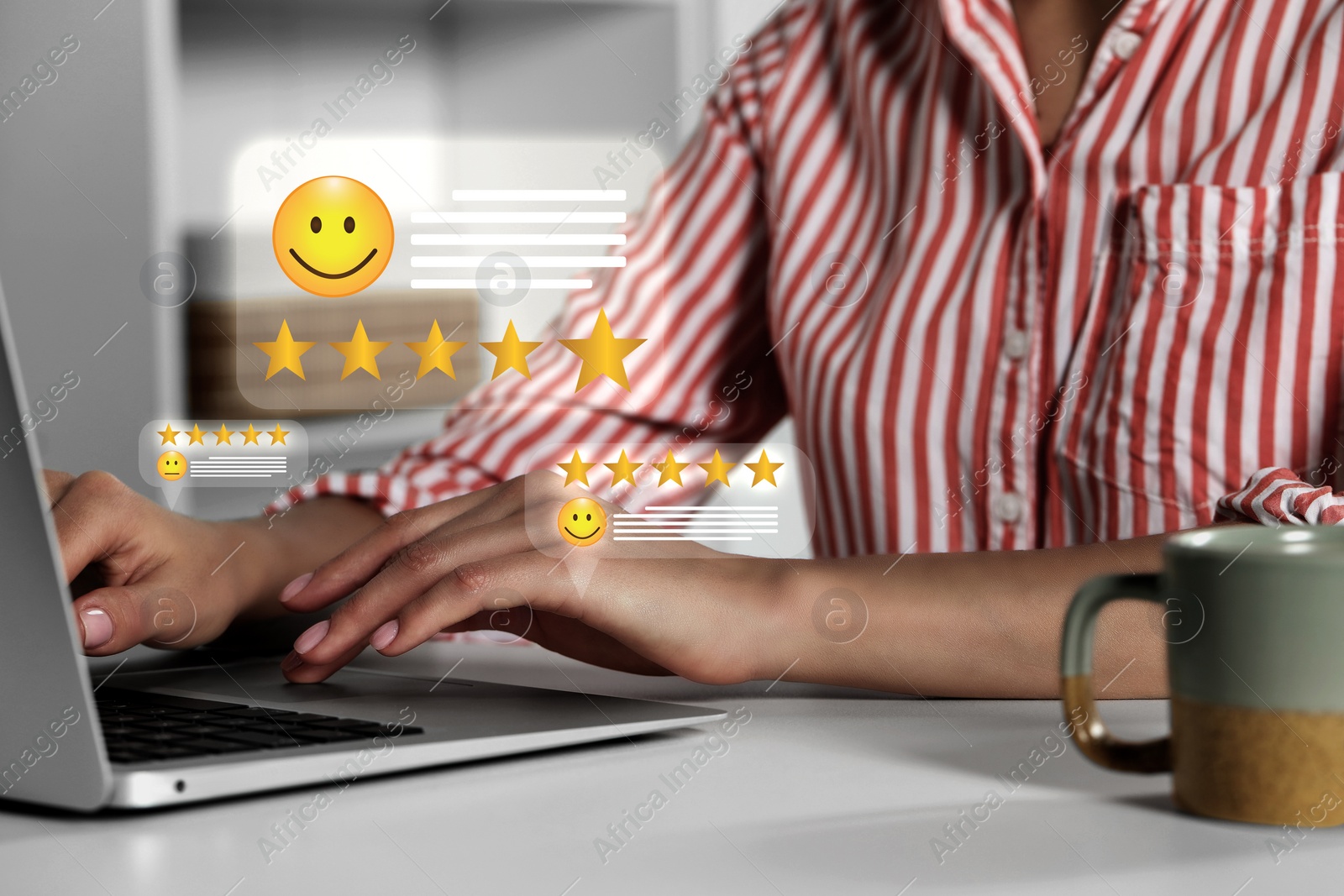 Image of Woman leaving service feedback using laptop at table, closeup. Stars and emoticons near device