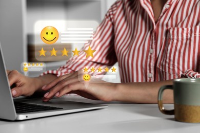 Woman leaving service feedback using laptop at table, closeup. Stars and emoticons near device