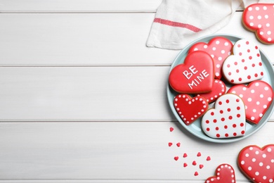Photo of Heart shaped cookies on white wooden table, flat lay with space for text. Valentine's day treat