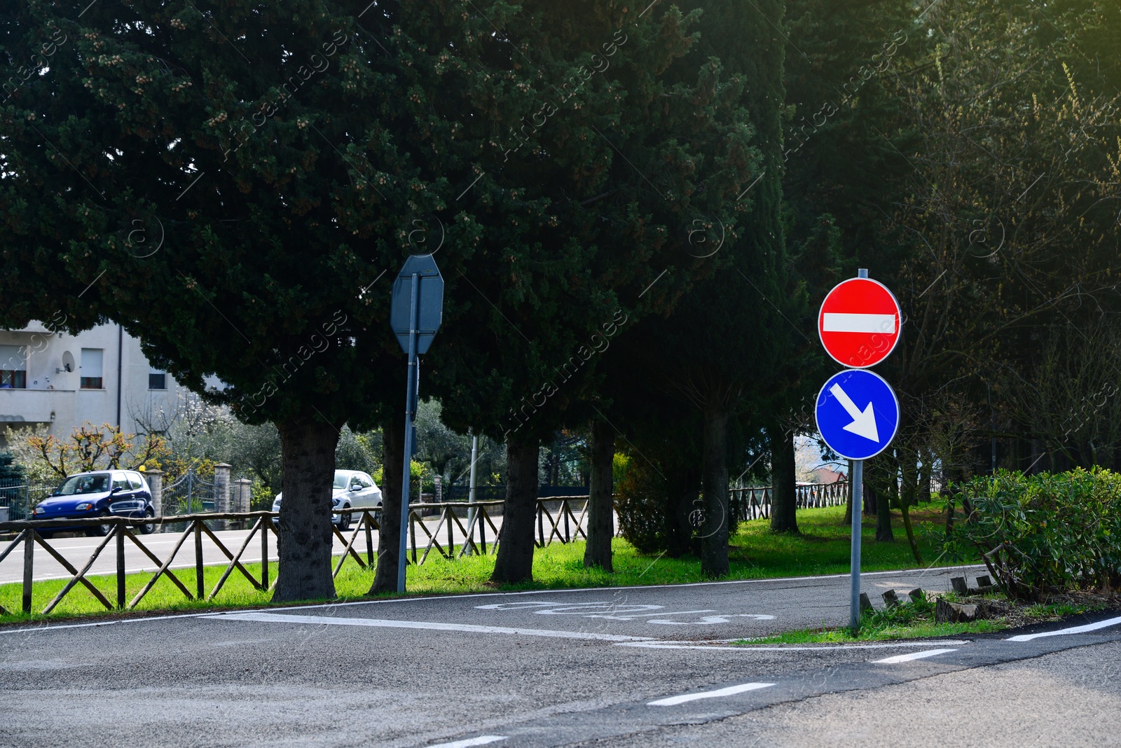 Photo of Post with traffic signs on city road