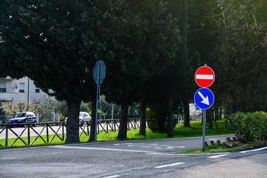 Post with traffic signs on city road