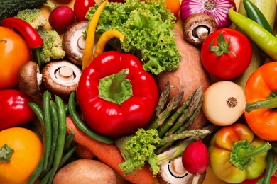 Different fresh vegetables as background, top view