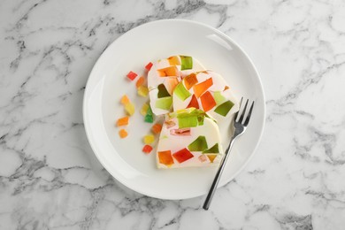 Delicious broken glass jelly dessert on white marble table, top view