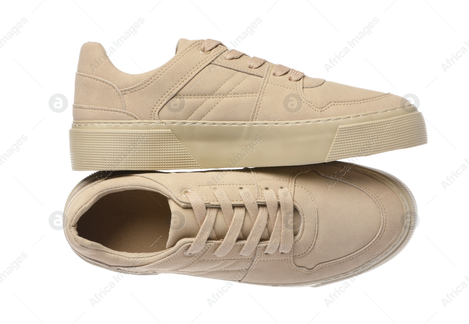 Photo of Pair of stylish beige sneakers isolated on white