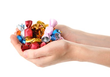 Woman holding heap of candies in colorful wrappers isolated on white, closeup