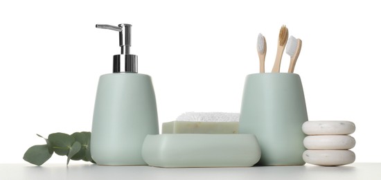 Photo of Bath accessories. Different personal care products and eucalyptus branch on table against white background