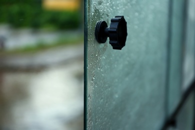 Photo of Open tram window with rain drops, closeup view