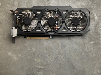 Photo of One graphics card on grey table, top view. Space for text