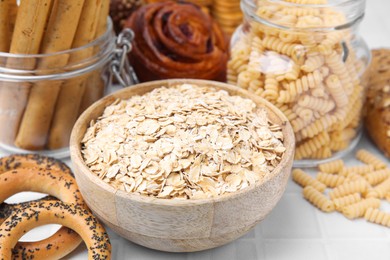 Photo of Different gluten free products on white tiled table, closeup