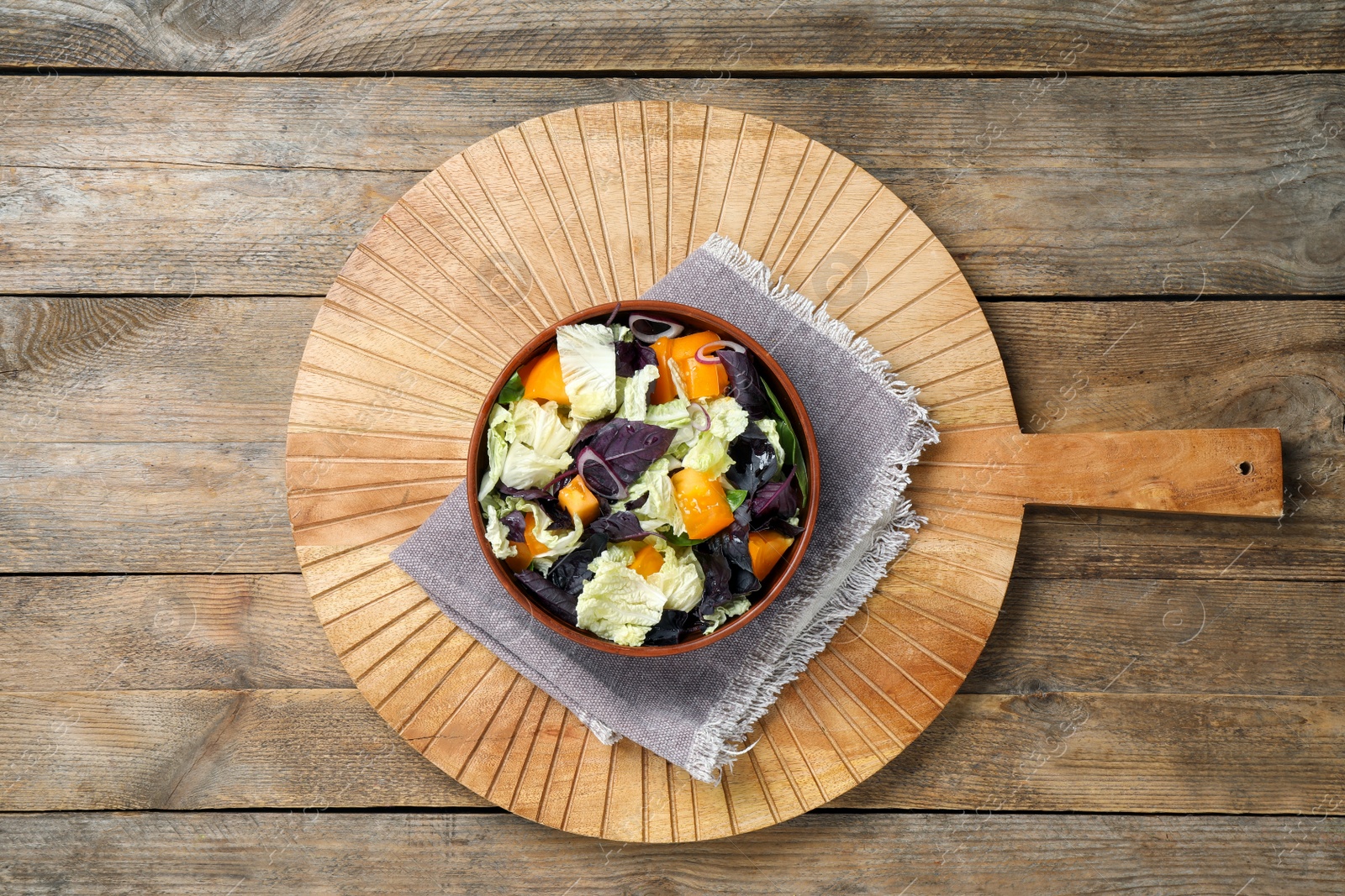 Photo of Delicious salad with Chinese cabbage, tomato and basil on wooden table, top view