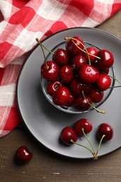 Wet red cherries on wooden table, flat lay