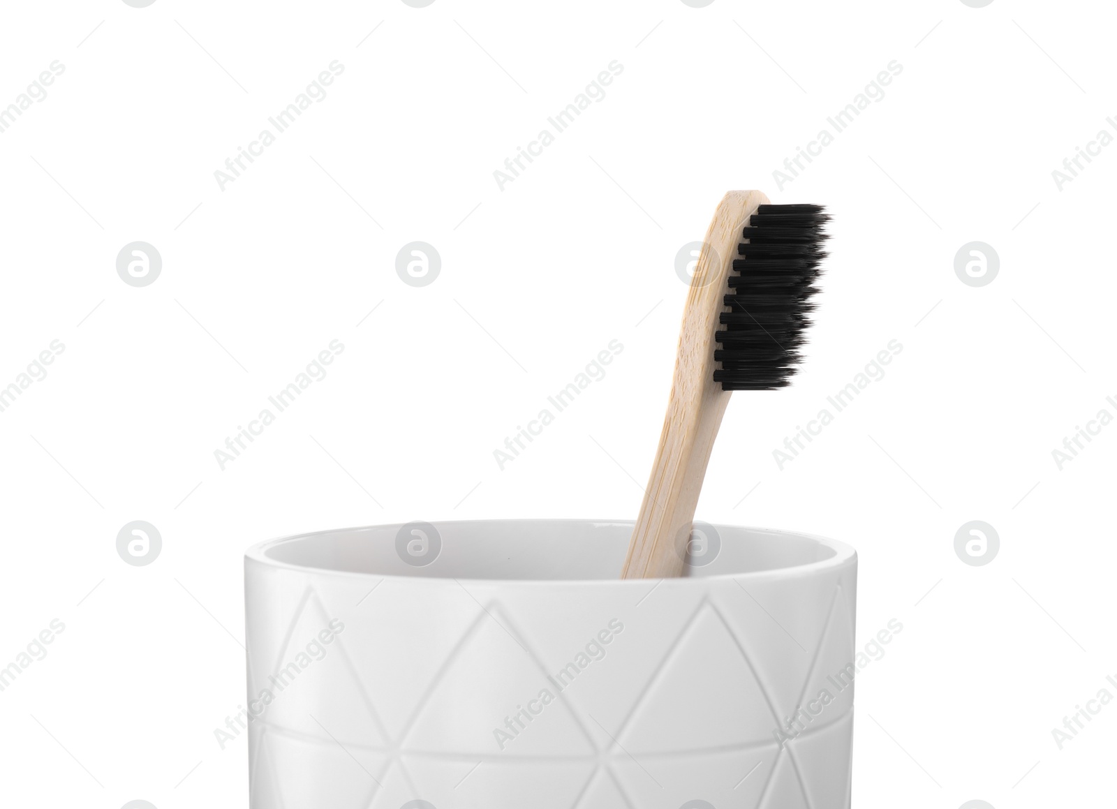 Photo of Bamboo toothbrush in holder isolated on white