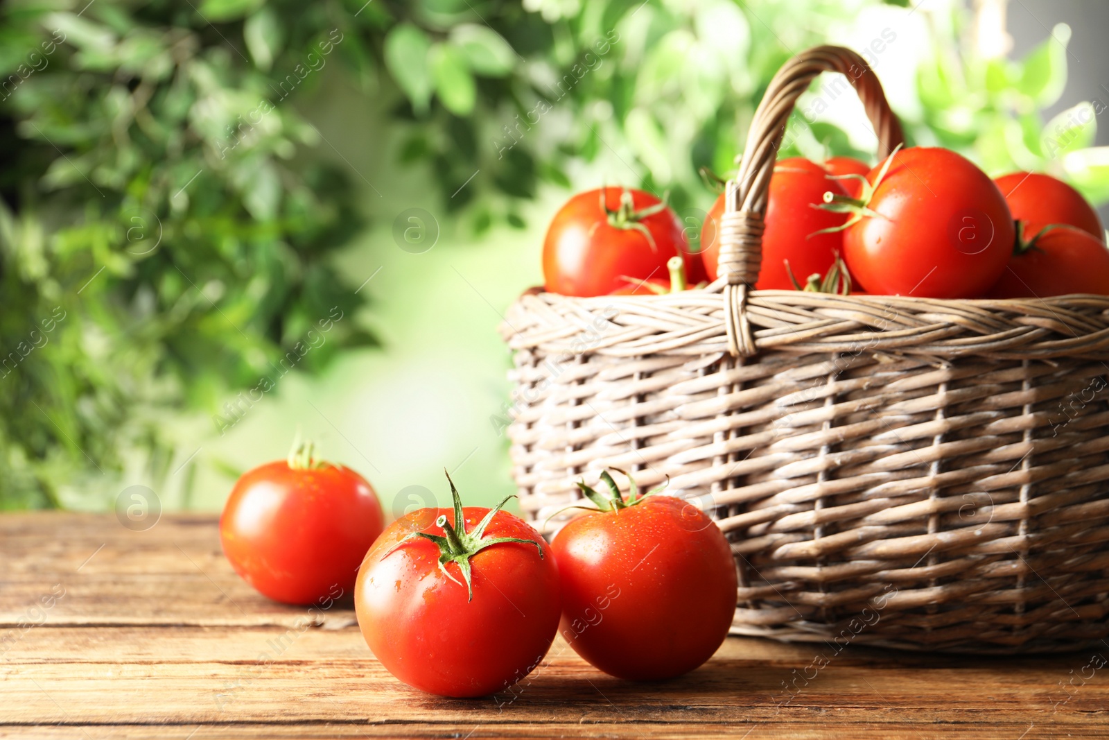 Photo of Fresh ripe red tomatoes on wooden table