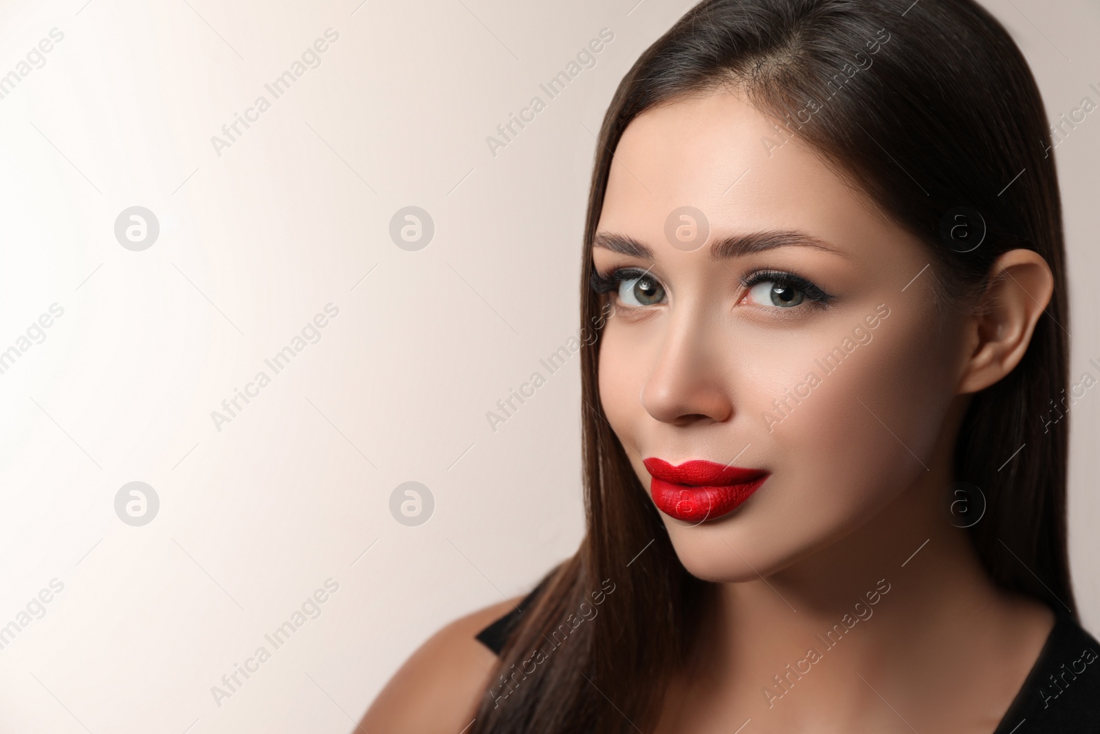 Photo of Beautiful woman with red lipstick on light background, space for text