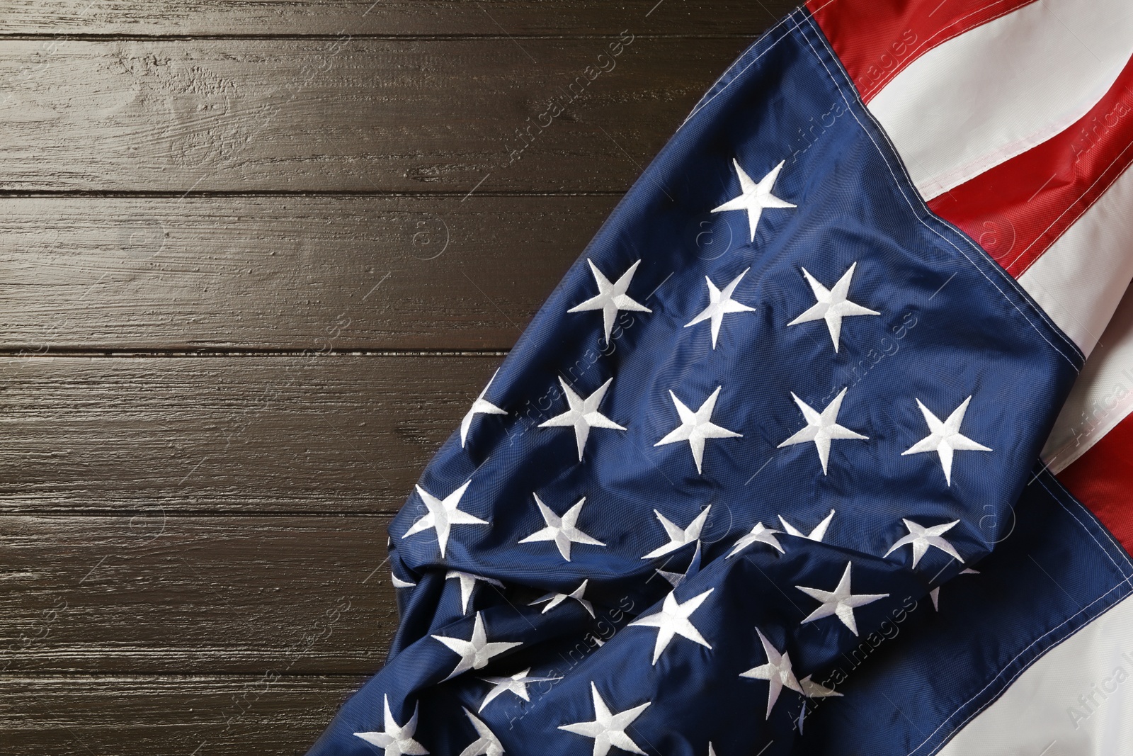 Photo of American flag on wooden table, top view with space for text. Memorial Day