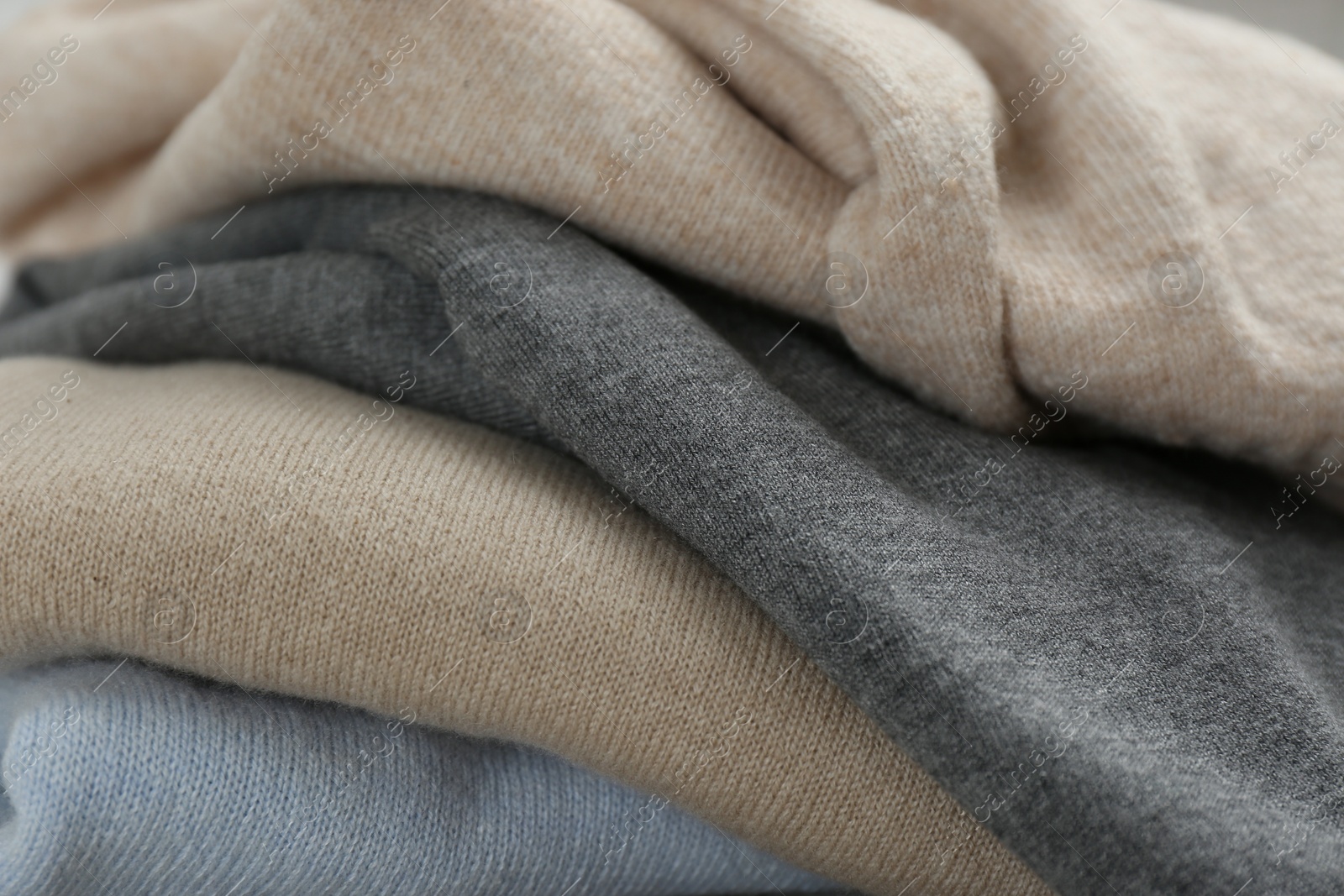 Photo of Stack of cashmere clothes as background, closeup