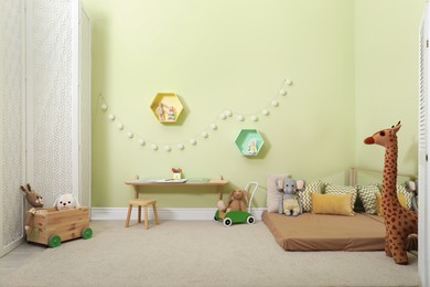 Photo of Montessori bedroom interior with floor bed and toys