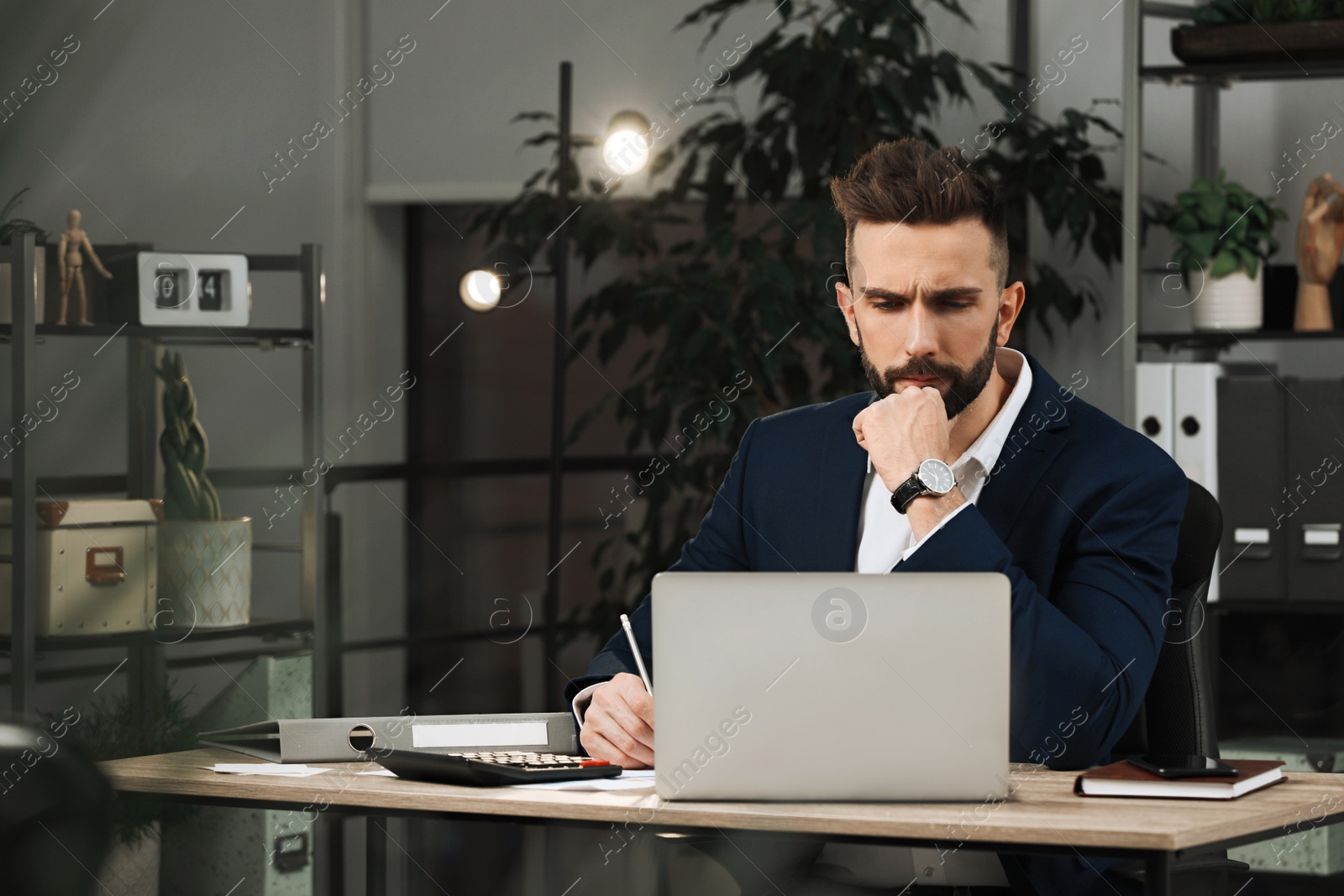 Photo of Man working on laptop at table in office, space for text