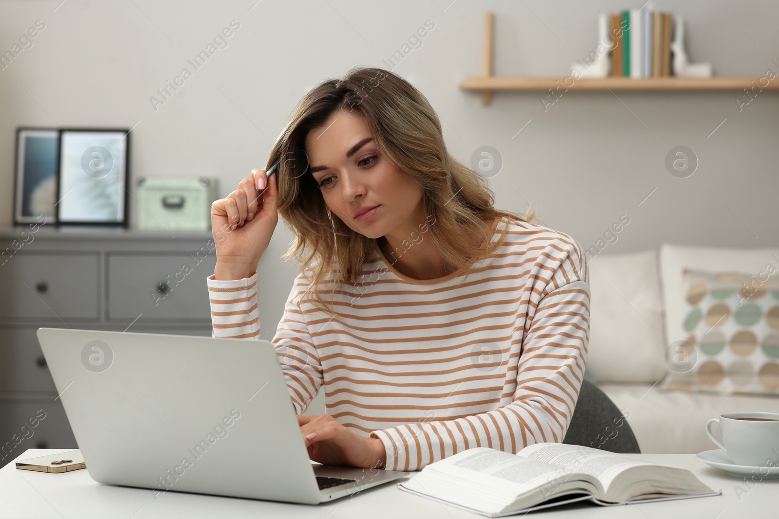 Photo of Online test. Woman studying with laptop at home