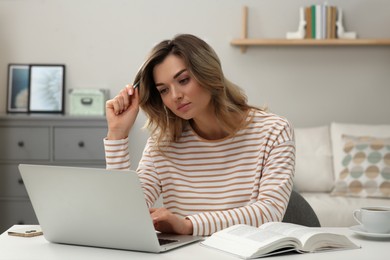 Photo of Online test. Woman studying with laptop at home