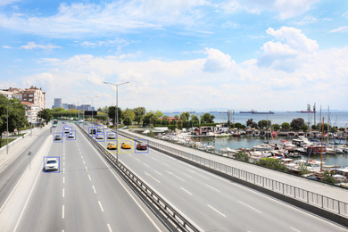 City road with scanner frames on cars near sea. Machine learning