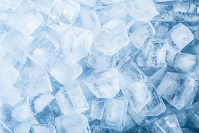 Photo of Crystal clear ice cubes as background, top view