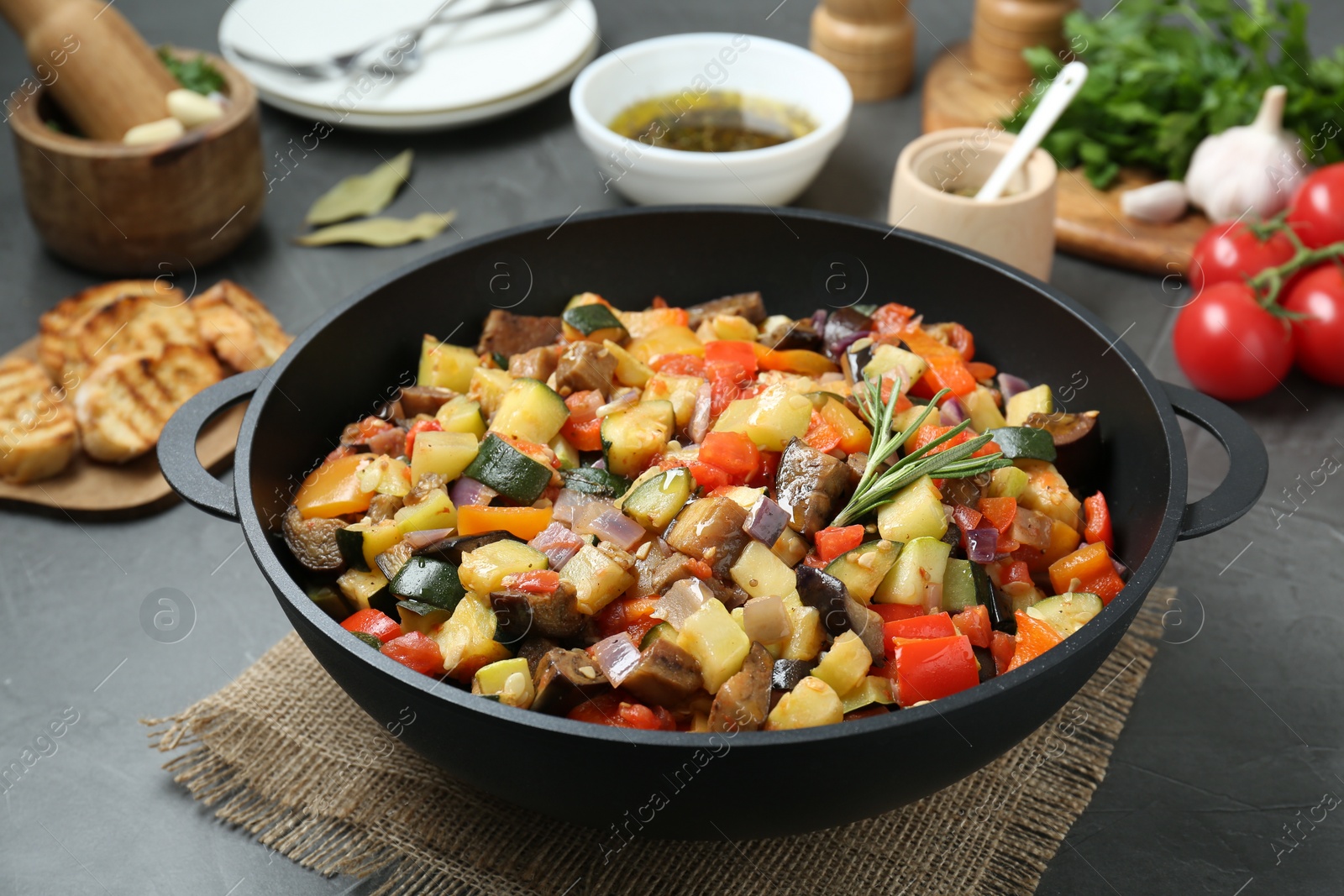 Photo of Delicious ratatouille served on grey table, closeup