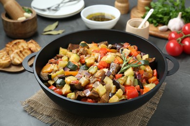 Photo of Delicious ratatouille served on grey table, closeup