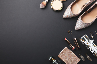 Photo of Flat lay composition with cosmetics and stylish accessories on black background. Space for text