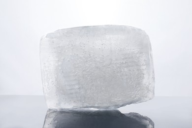 Photo of One cold ice cube isolated on white