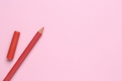 Photo of Lip pencil on pink background, flat lay with space for text. Cosmetic product