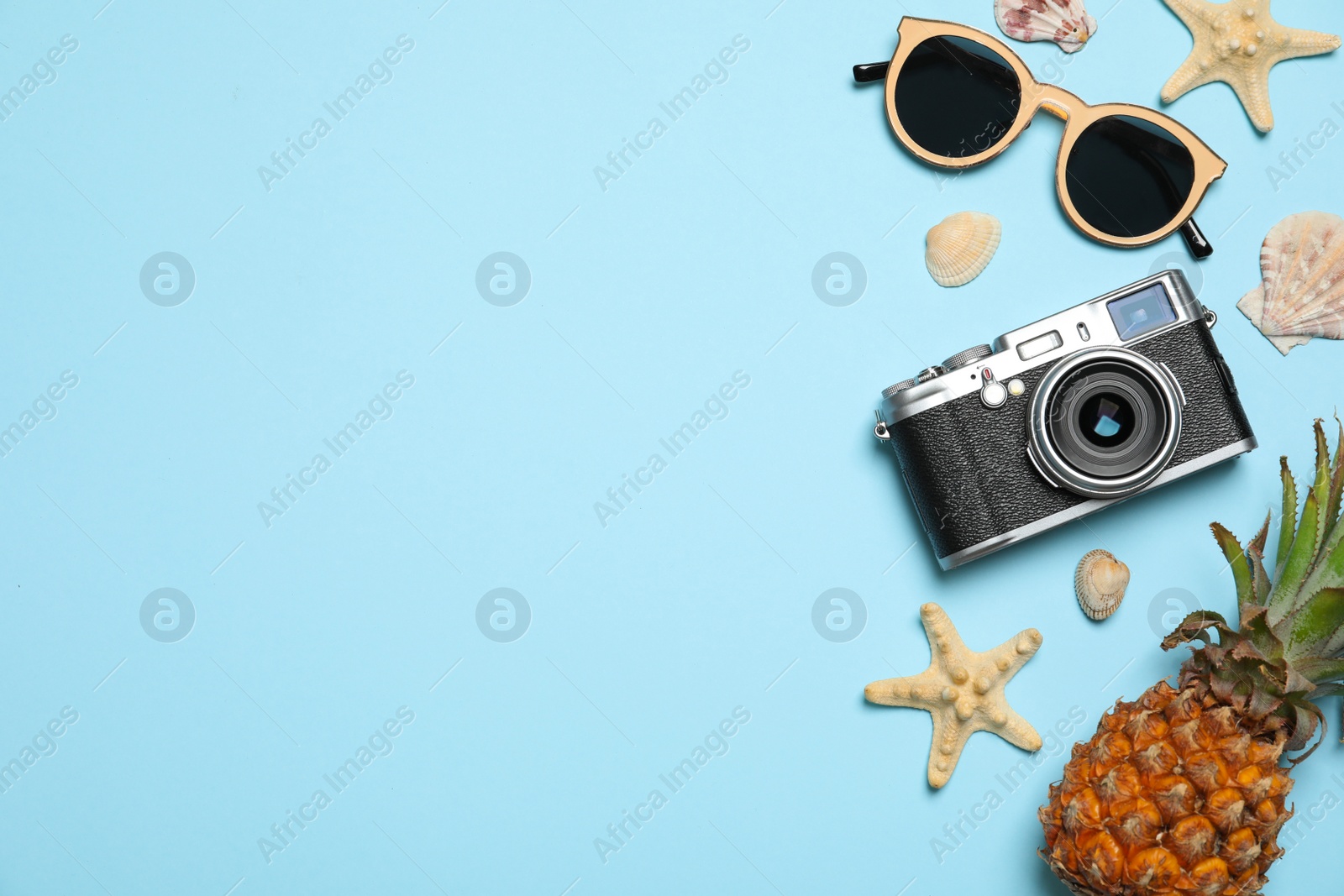 Photo of Flat lay composition with camera and sunglasses on color background, space for text. Beach accessories