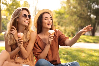 Photo of Young women with ice cream spending time together outdoors