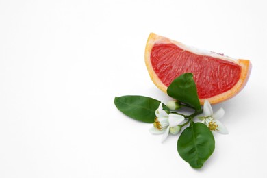 Photo of Cut fresh ripe grapefruit and green leaves on white background. Space for text