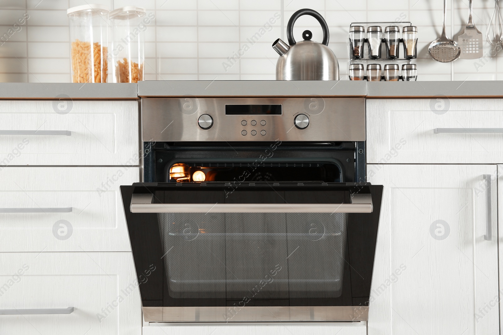 Photo of Open modern oven built in kitchen furniture