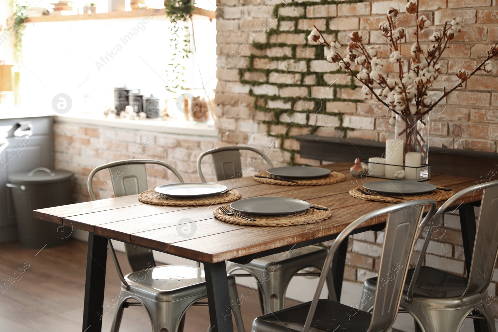 Photo of Stylish kitchen interior with dining table and chairs