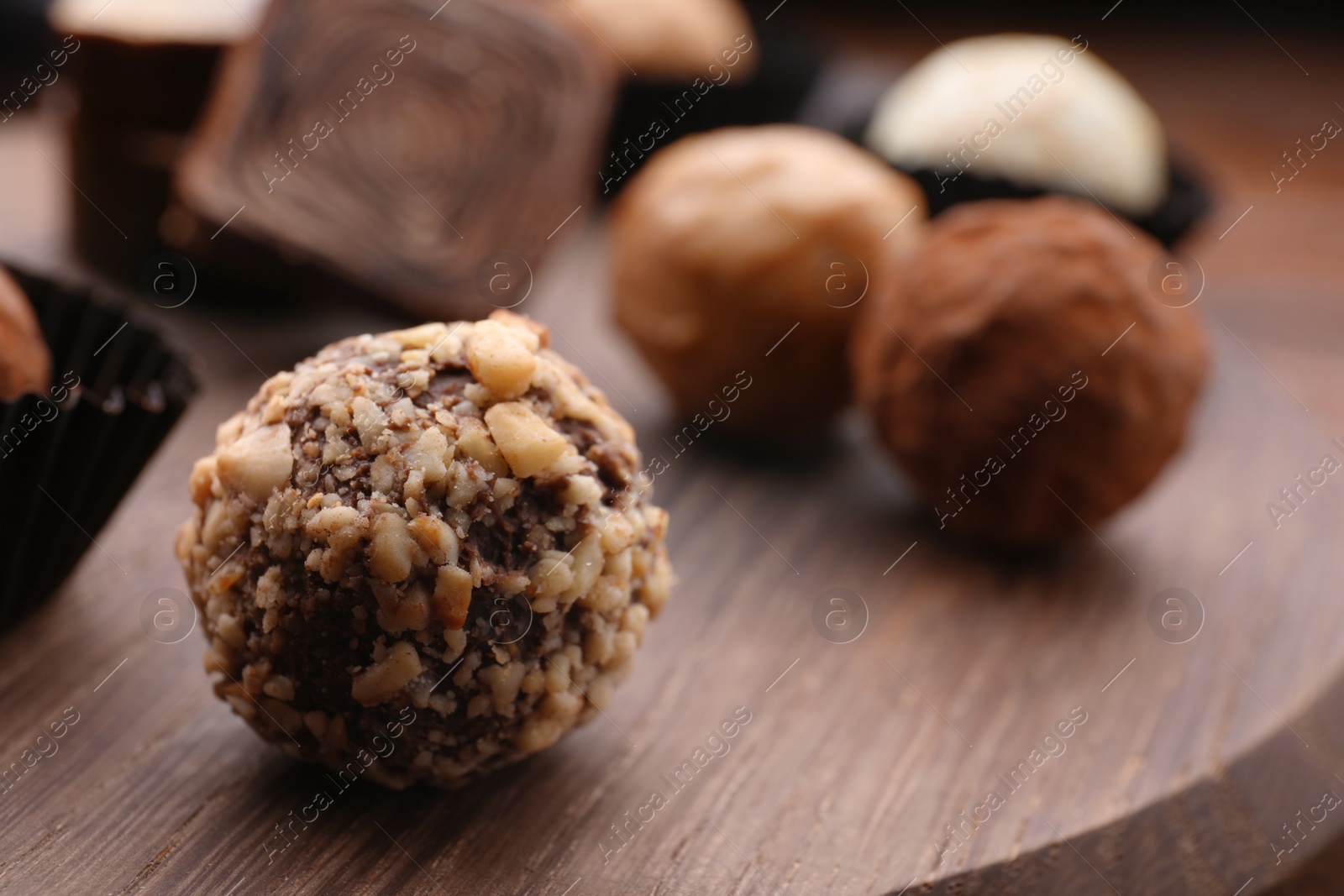 Photo of Tasty chocolate candies on table, closeup. Space for text