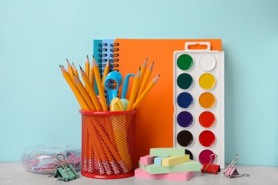 Photo of Different school stationery on table against light blue background. Back to school