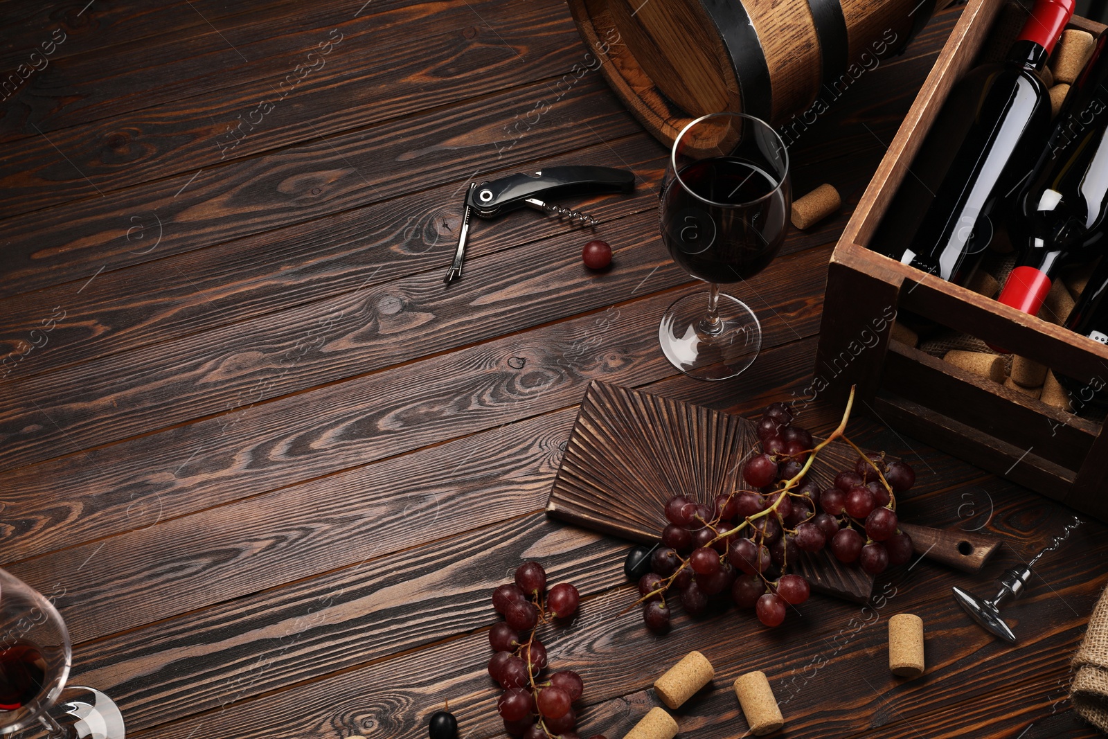 Photo of Winemaking. Composition with tasty wine and barrel on wooden table, above view. Space for text