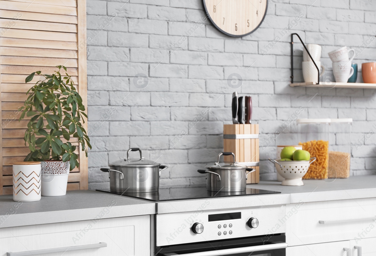 Photo of Modern kitchen interior with new furniture and different utensils