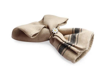 Photo of Beige cloth napkin with decorative ring for table setting isolated on white
