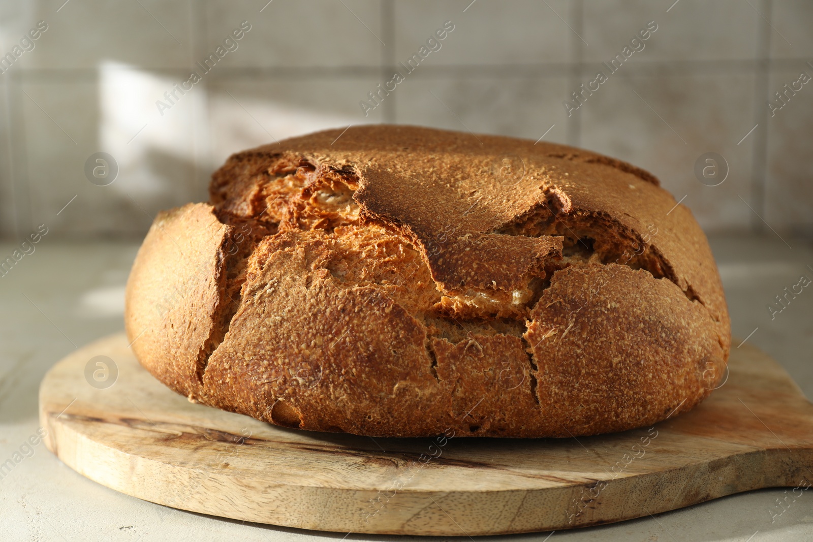 Photo of Freshly baked sourdough bread on light table, closeup