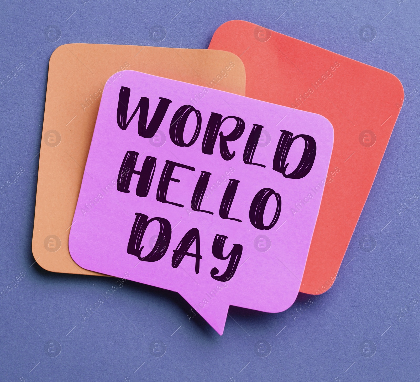 Image of Paper note with phrase World Hello Day on color background, top view