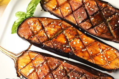 Photo of Plate with fried eggplant slices, top view