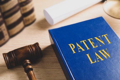 Image of Patent Law book and gavel on wooden table