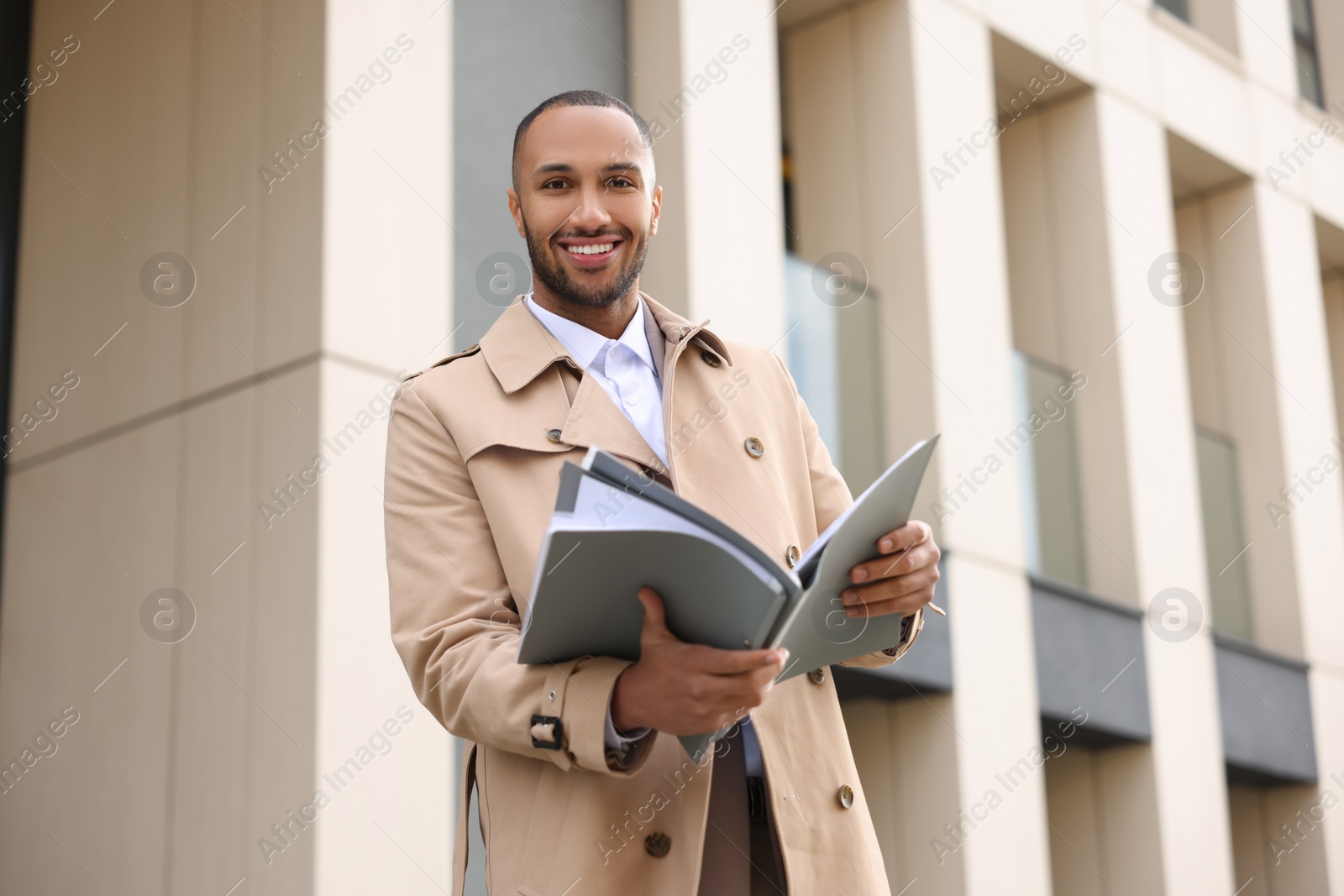 Photo of Happy man with folders outdoors. Lawyer, businessman, accountant or manager