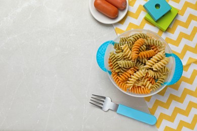 Photo of Flat lay composition with bowl of tasty fusilli pasta on white table, space for text