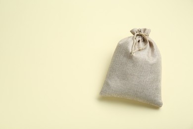 Photo of Burlap bag on beige background, top view. Space for text